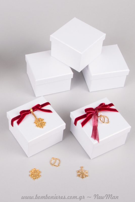 Μπομπονιέρα σε λευκό ή εκρού κουτί (7 x 7 x 5cm) με μπορντό και χρυσαφένια διακοσμητικά στοιχεία.